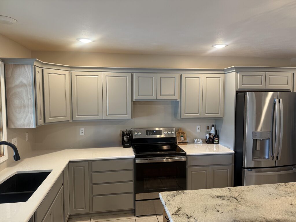 Modern kitchen with white shaker cabinets, subway tile backsplash, and a stainless steel smart refrigerator.