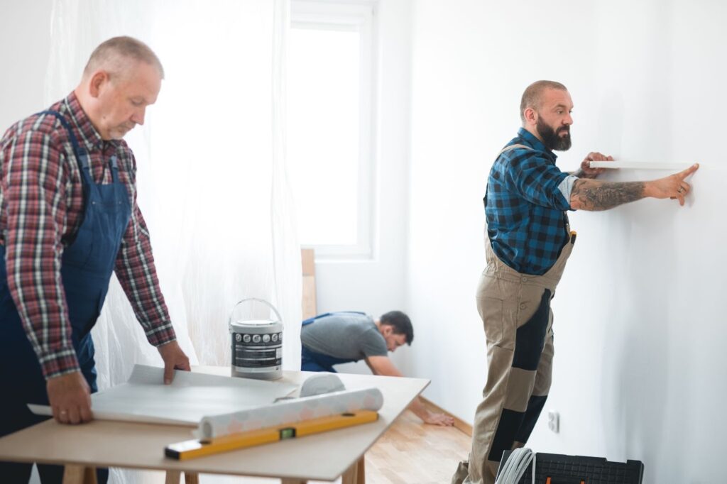 Three professional home remodeling crews working together on an apartment renovation project.