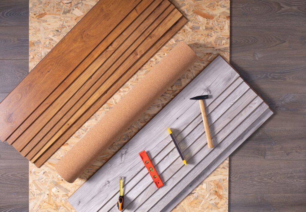 Wood planks with hand tools displayed on a natural wood background texture.