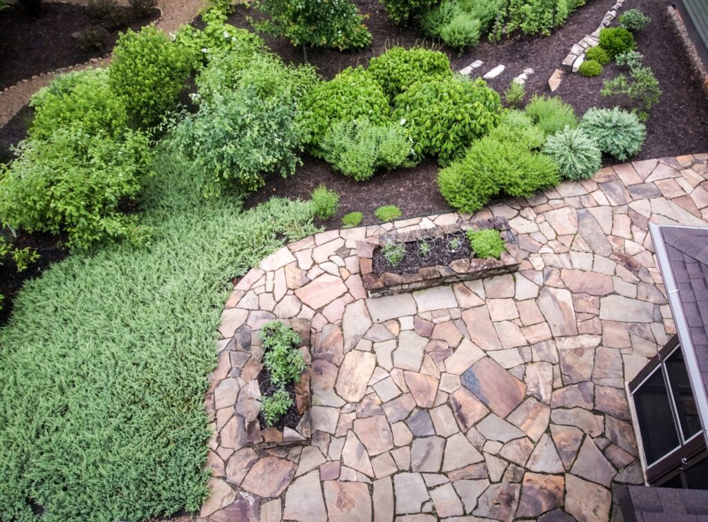 Bird’s-eye view of a landscaped garden patio featuring Tennessee flagstone with surrounding greenery and seating areas