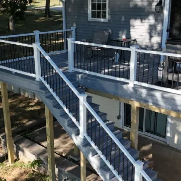 A newly constructed multi-level composite deck with white and black railings, built by KB Builders LLC.